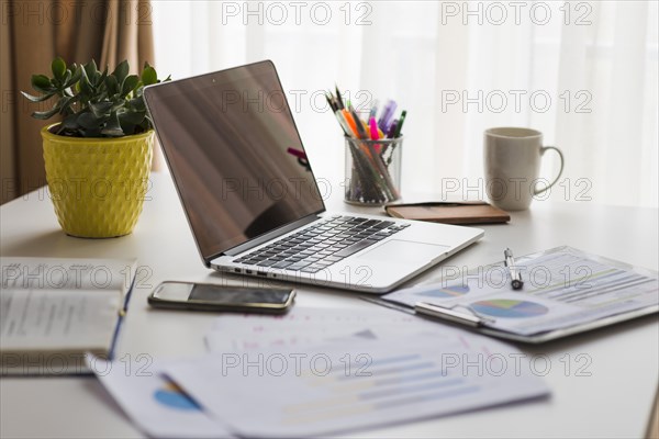 Papers laptop office table