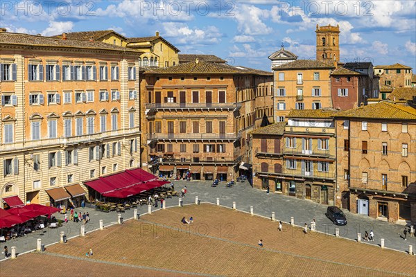View of the Piazza del Campo with street cafes under red awnings
