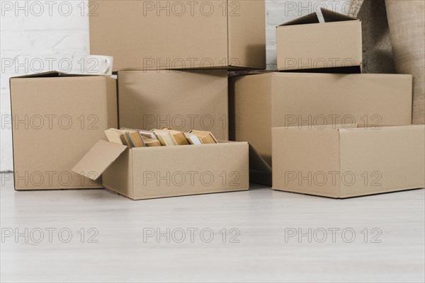 Pile cardboard boxes white floor