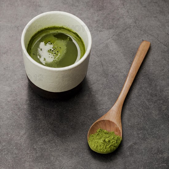 Close up matcha tea cup with wooden spoon