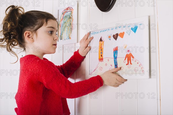 Girl hanging picture frame wall