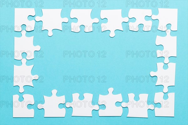 High angle view jigsaw puzzle frame blue backdrop