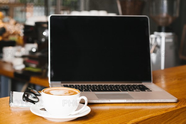 Frontview laptop coffee wooden surface