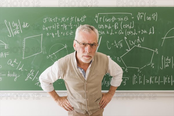 Serious aged professor lecture room looking camera