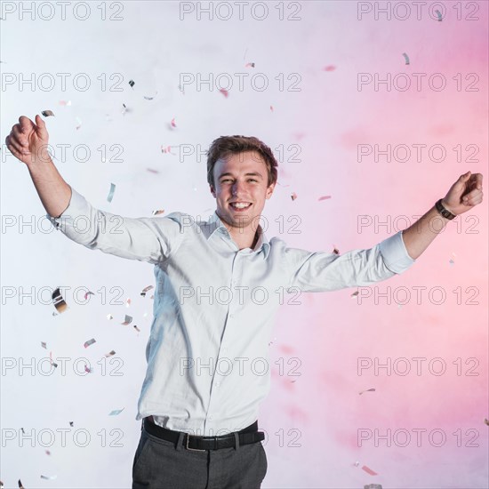 Boy posing with confetti new year party