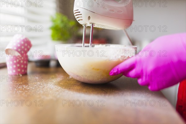 Crop hands mixing batter glass bowl