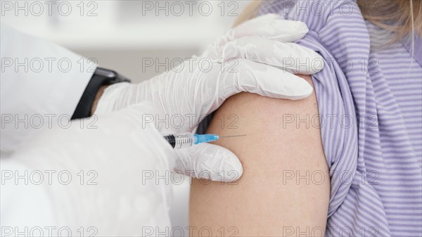 Doctor vaccinating patient clinic