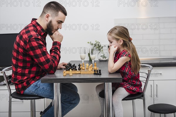 Father daughter playing chess fathers day