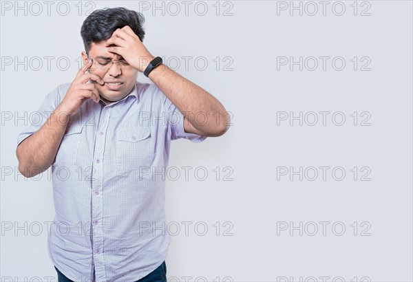 Exhausted person putting the palm of his hand on his face. Fatigued and exhausted man isolated. Concept of a bored and tired man