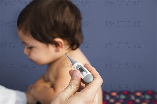 Close up doctor checking baby temperature