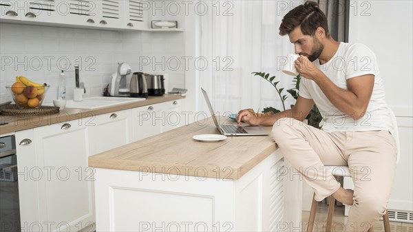 Adult male casually working from home