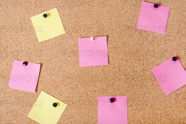 Close up corkboard with various note papers