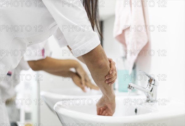 Doctor washing hands clinic