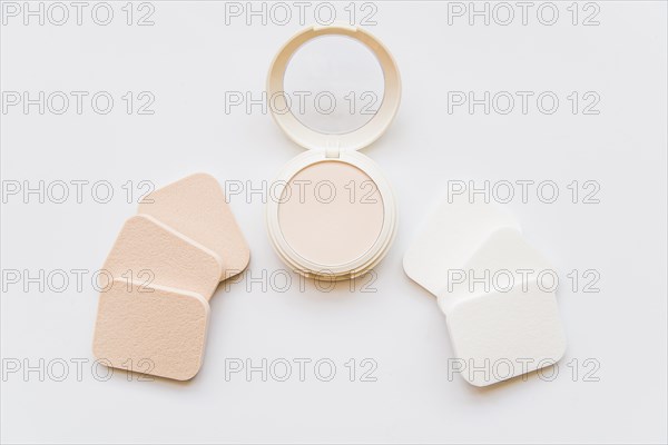 Face cosmetic compact makeup powder with sponges white background