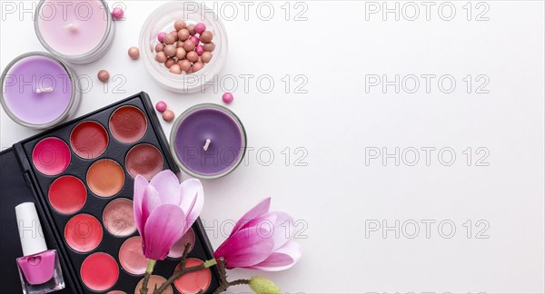 Top view make up products candles with copy space