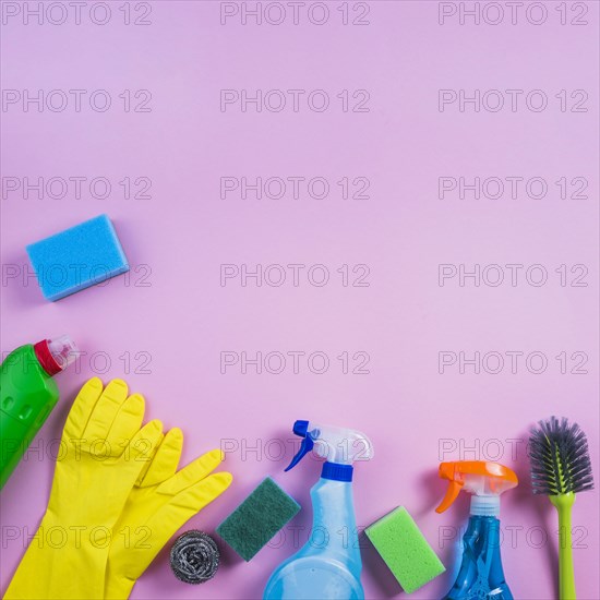 Elevated view cleaning products pink background