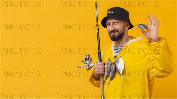 Fisherman holding fishing rod with bait