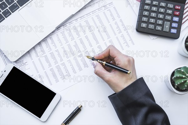 Hand holding fountain pen office desk