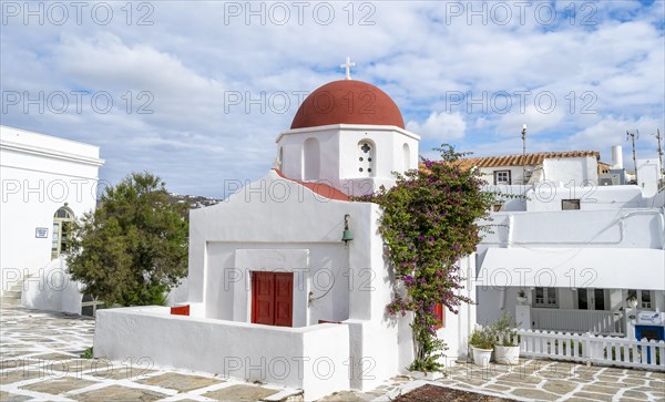 White Greek Orthodox Church of St Nicholas with red roof and bougainvillea