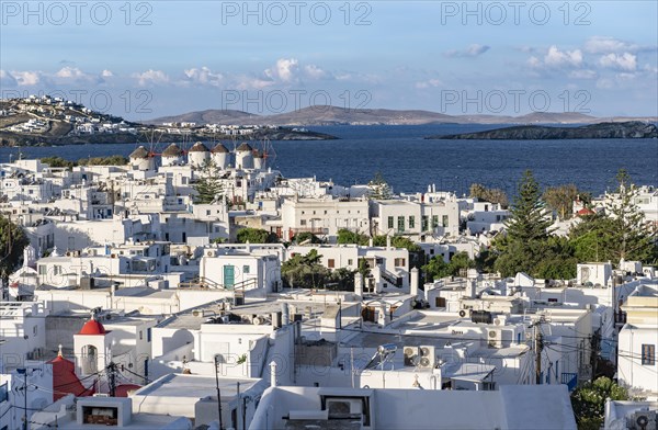 View over white Cycladic houses and windmills