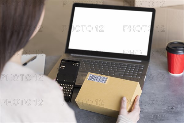 High angle woman looking up bar code box she s holding