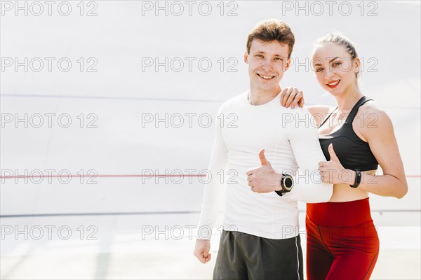 Medium shot sporty couple approving