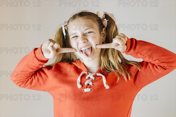 Portrait girl sticking out tongue