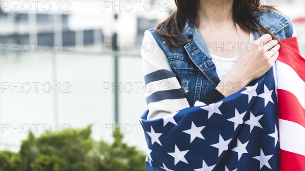 Woman wrapped big american flag