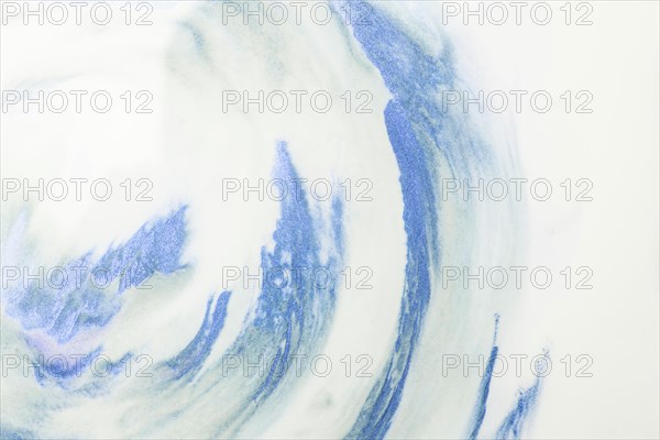 Close up blue watercolor strokes white foam background