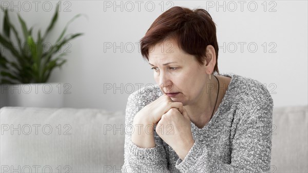 Front view woman with anxiety couch