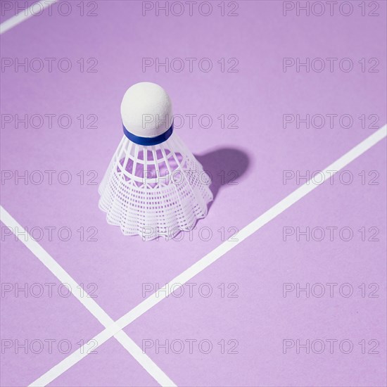 High angle shuttlecock purple background