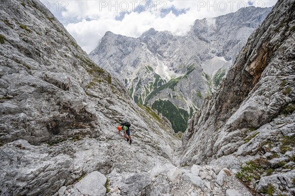 Mountaineer climbing in steep rocky terrain on the way to Waxenstein