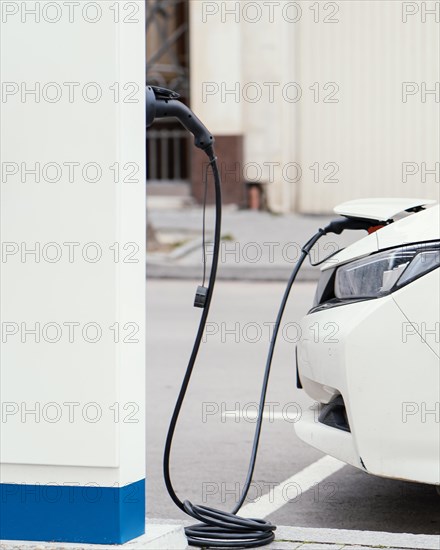 Side view car being charged electric vehicle charging station