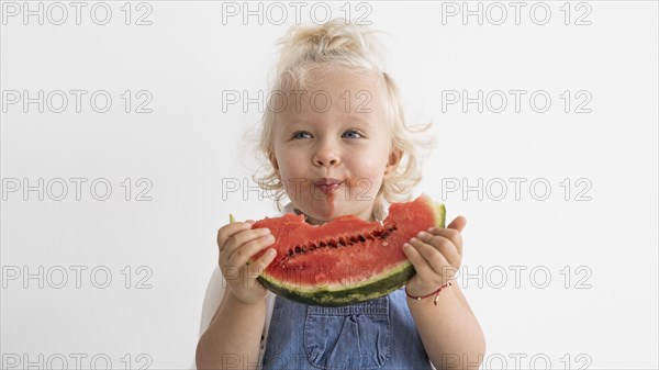 Adorable baby playing with food