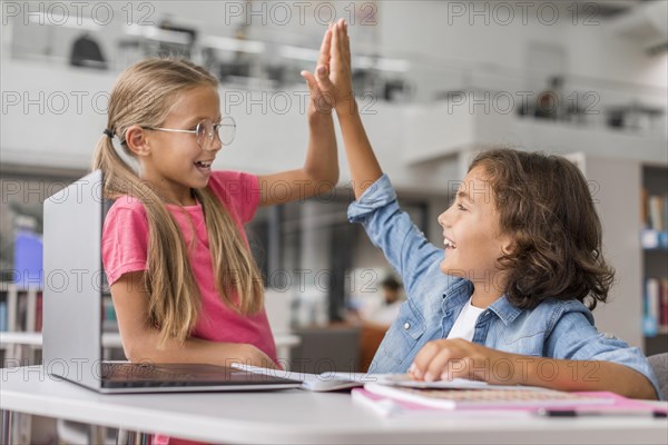 Kids high fiving library