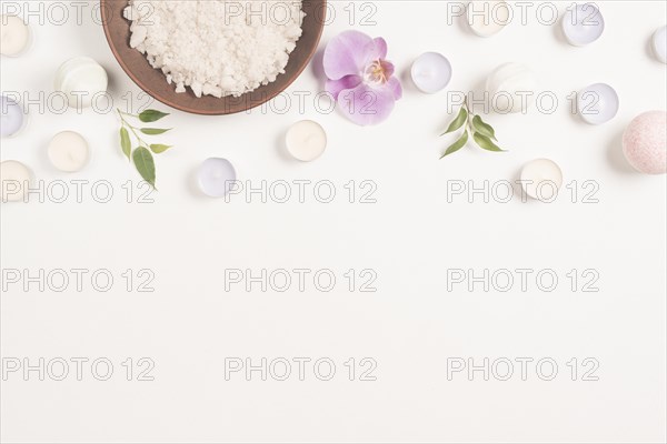Sea salt orchid flower with candles white background forming top border