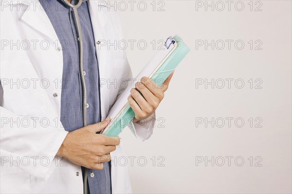 Doctor s hands with clipboard folder