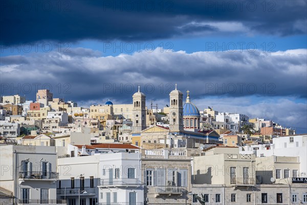 View of the town of Ermoupoli with pastel-coloured houses and the church of St Nicholas