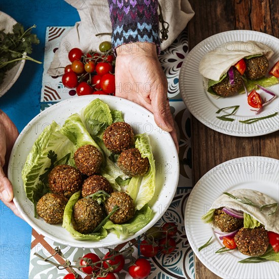 Close up hands holding plate with jewish food