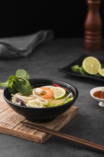 High angle soup with noodles chopsticks