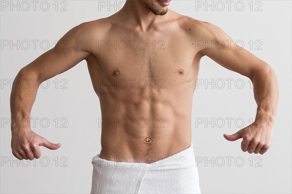 Front view shirtless man showing off his abs