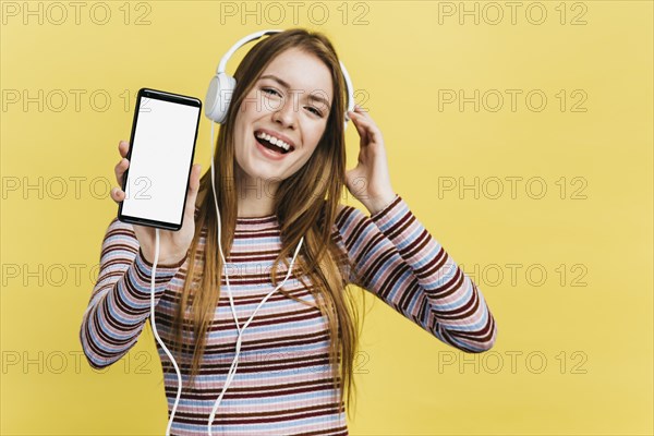 Happy woman listening music phone mock up