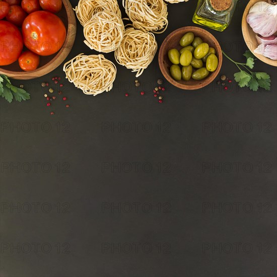 Ingredients making tagliatelle pasta black background