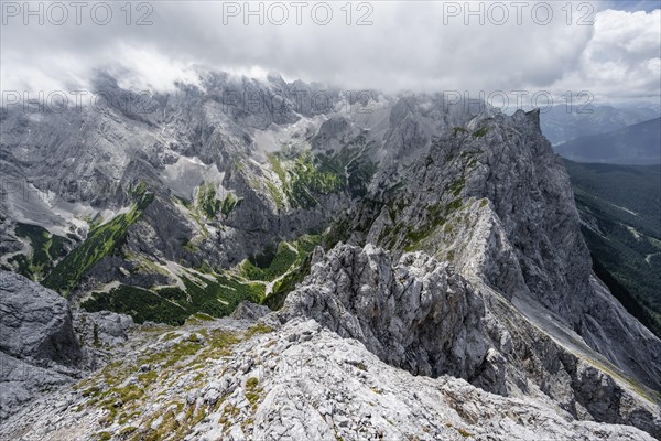 View from the summit of the Waxenstein over rocky and narrow ridge of the Waxenstein ridge to Hoellental with Jubilaeumsgrat