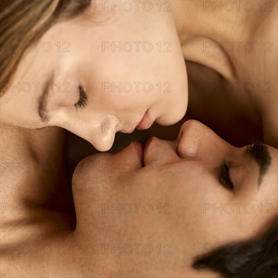 Close up shirtless man woman almost kissing