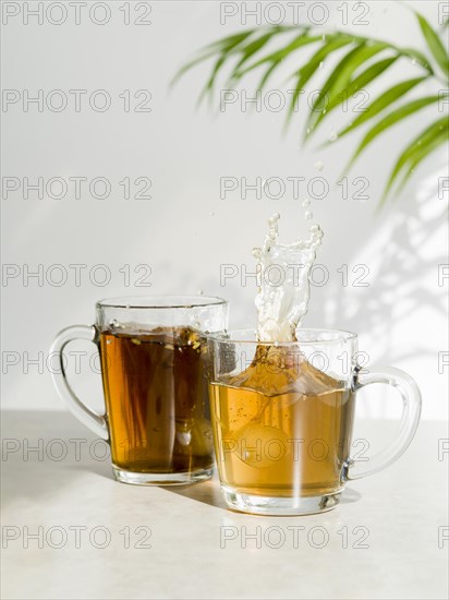 Front view tea splashing glass