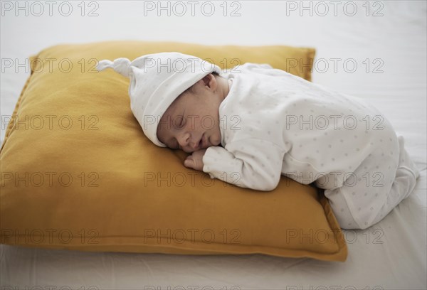 Cute baby sleeping yellow pillow