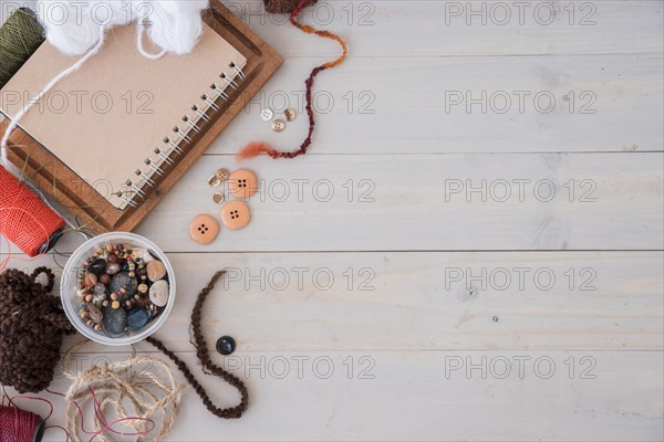 Wools beads string spool wooden desk