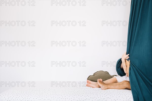 Girls hiding curtains