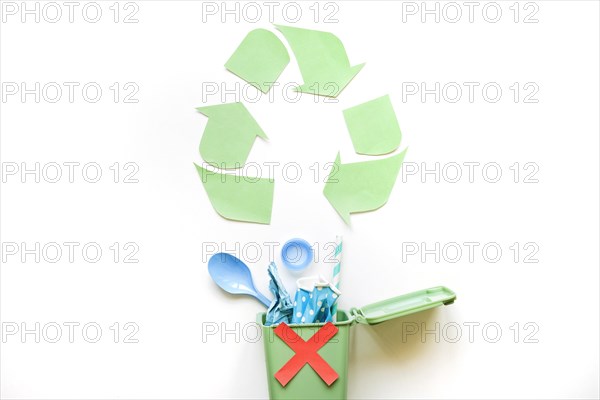 Recycle symbol bin with plastic rubbish